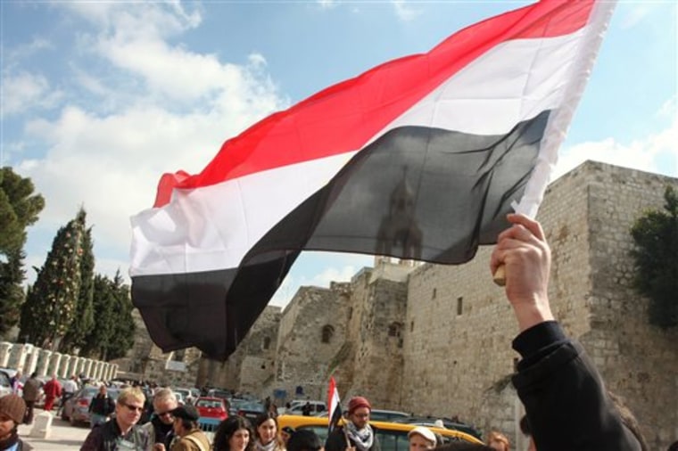 A Palestinian holds up an Egyptian flag during a demonstration in support of the Egyptian people, outside the Church of Nativity, traditionally believed by many Christians to be the birthplace of Jesus Christ, in the West Bank town of Bethlehem, on Sunday.